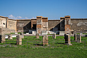 Columns of the tholos in the Macellum or marketplace, VII.9.7, in the ancient Roman ruins of Pompeii, Italy.