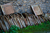 A stack of original ceramic tiles in a building in the ancient Roman ruins of Pompeii, Italy.