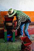 A vintage manually-operated coffee bean depulper machine on a small coffee plantation in Colombia.