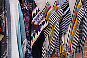 Woven ponchos for sale in a tourist souvenir shop in El Peñol, Colombia.