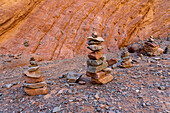 Balancing rock cairns made by tourists in the Amphitheater or Anfiteatro on RN 68 in the Quebrada de las Conchas, Argentina.