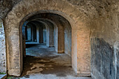 A circular corridor under the Amphitheater of Pompeii in the ancient Roman ruins of Pompeii in Italy.
