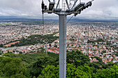 Cable cars of the Teleferico San Bernardo aerial tramway over San Bernardo Hill in Salta, Argentina.