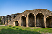 The exterior of the Amphitheater of Pompeii in the ancient Roman ruins of Pompeii in Italy.