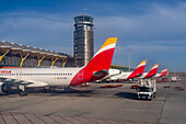 Terminal T4, control tower & Iberian Airlines jetliners at Adolfo Suárez Madrid–Barajas Airport, Madrid, Spain.
