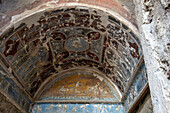 Colorful frescoes in the House of the Lararium of Achilles, Building I.6.4, in the ancient Roman ruins of Pompeii, Italy.