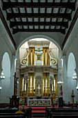 Worshippers in the nave of the Basilica of Our Lady of Candelaria, Medellin, Colombia.