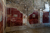 Colorful frescoes in the House of the Lararium of Achilles, Building I.6.4, in the ancient Roman ruins of Pompeii, Italy.