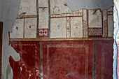 Colorful fresco in the Fullery of Stephanus, Building I.6.7, in the ancient Roman ruins of Pompeii, Italy.