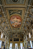 Painted ceiling in the Great Hall of the Sundial in the National Archaeological Museum of Naples, Naples, Italy. The three-dimensional appearance of the ceiling is an optical illusion, created by the artists.