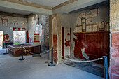 Interior of the Fullery of Stephanus, Building I.6.7, in the ancient Roman ruins of Pompeii, Italy, with a washing vat at left.
