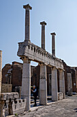 Columns along the Forum at the east end of the Basilica in the ancient Roman ruins of Pompeii, Italy.