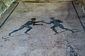Mosaic floor with wrestlers in the Palestra dei Iuvenes, Building VIII.2.23, in the ancient Roman ruins of Pompeii, Italy. The name means Juvenile Gymnasium.