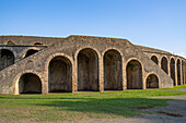 The exterior of the Amphitheater of Pompeii in the ancient Roman ruins of Pompeii in Italy.