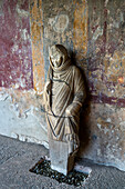 A marble statue of a woman in the Stabian Baths of Terme Stabiane of the ancient Roman ruins of Pompeii in Italy.