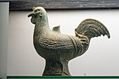 A small statuette of a rooster in the Vesuvian Life Gallery, National Archaeological Museum of Naples, Naples, Italy. The lead-glazed terra cotta figure is from Pompeii, circa 1st Century A.D.