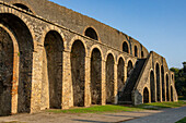 The exterior of the Amphitheater of Pompeii in the ancient Roman ruins of Pompeii in Italy.
