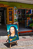 A humorous Botero-style Mona Lisa in front of an art gallery in the tourist town of Guatape, Colombia.