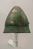 A Pilos-style bronze helmet in the National Archaeological Museum of Naples, Naples, Italy. From Ruvo, Ruvo, circa 4th Century B.C. Magna Graecia Collection.