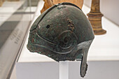 A bronze military helmet in the National Archaeological Museum of Naples, Naples, Italy. Circa 4th Century B.C., from Canosa, Monterisi-Rossignol. Magna Graecia Collection.