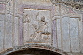 Bas relief of Zeus on the stucco wall of the nyphaeum of the Stabian Baths in the ancient Roman ruins of Pompeii, Italy.