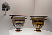 4th Century Gnathia-style bell kraters & bronze helmet in the National Archaeological Museum of Naples, Naples, Italy. Magna Graecia Collection. From Egnatia.