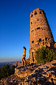 Young woman enjoying the sunset views from Grand Canyon Desert View Watchtower, Arizona