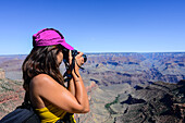 Young caucasian female photographer shooting in Grand Canyon, Arizona