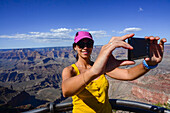 Young caucasian woman taking a selfie in Grand Canyon viewpoint, Arizona
