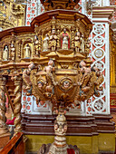 The ornately-carved pulpit in the nave of the Basilica of Our Lady of Mercy, Quito, Ecuador.