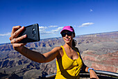 Young caucasian woman taking a selfie in Grand Canyon viewpoint, Arizona