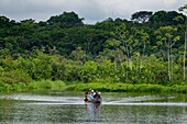 Touristen auf einer Wildtierbeobachtungstour in einem Kanu im Napo Wildlife Center im Yasuni-Nationalpark, Ecuador.
