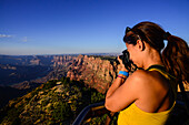 Young caucasian female photographer shooting in Grand Canyon, Arizona