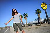 Young Caucasian woman hitchhiking on Route 66