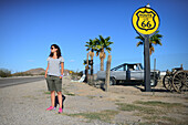 Young Caucasian woman standing by Route 66