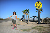 Young Caucasian woman hitchhiking on Route 66