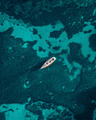 Aerial view of a beautiful sailing boat on the azure ocean, St. Julian's, Malta.