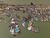 Aerial view of destroyed fishing village with damaged houses and debris after cyclone Sitrang, Potenga, Chittagong, Bangladesh.