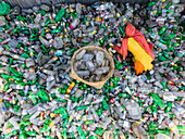 Narayanganj, Bangladesh - 09 November 2024: Aerial view of a woman worker recycling plastic bottles at a factory near a landfill, Narayanganj, Dhaka, Bangladesh.