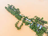 Aerial view of flooded village with houses and trees in a flooded area, Jhenaigati, Sherpur, Bangladesh.