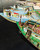 Savar, Bangladesh - 02 February 2025: Aerial view of busy boats and people working along the Buriganga river in a vibrant urban scene, Amin Bazar, Savar, Dhaka, Bangladesh.