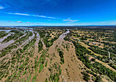 Aerial view of lush wetland with a serene river and picturesque greenery, Ban Khon Tai, Champasak, Laos.