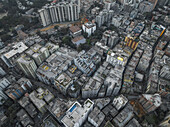 Aerial view of crowded urban skyline with modern high-rise buildings and beautiful sunset, Ramna Thana, Dhaka, Bangladesh.