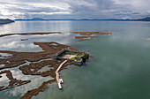 Aerial view of ali pasha's castle and lake butrint with serene reflections and scenic landscape, ksamil, vlore, albania.