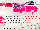 Aerial view of vibrant hand-dye fabrics drying in the sun at a factory, Narayanganj, Dhaka, Bangladesh.