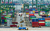 Singapore - 13 December 2024: Aerial view of Pasir Panjang Port container terminal with stacked shipping containers and cranes, South West Community Development Council, Singapore.