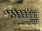 Aerial view of parked trucks in an organized fleet on a large scale logistics center, Suti Para Union, Dhamrai, Dhaka, Bangladesh.