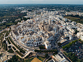 Aerial view of the beautiful medieval old town with white stone buildings and residential areas, Locorotondo, Bari, Italy.