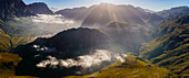 Aerial view of majestic mountains and a serene valley under sunlight with clouds, Miaspoort, Du Toitskloof pass, Cape Town, South Africa.