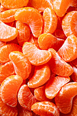 A vibrant close-up of fresh, juicy tangerine slices that bring out their natural, bright orange colour. Perfectly peeled segments symbolise the freshness and vibrancy of citrus fruits.